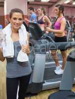 Woman holding towel in gym
