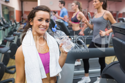 Woman smiling with bottle of water