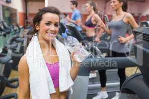 Woman smiling with bottle of water