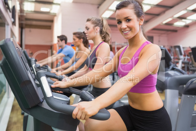 Woman smiling on exercise bicycle