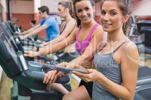 Instructor and woman smiling in the gym