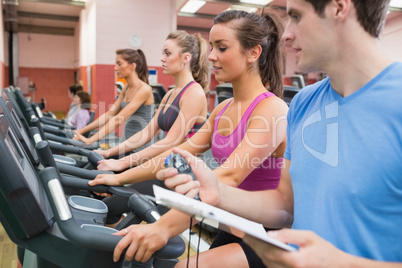 Instructor with stopwatch in gym