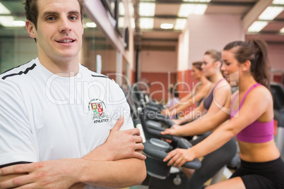 Man with arms crossed in gym