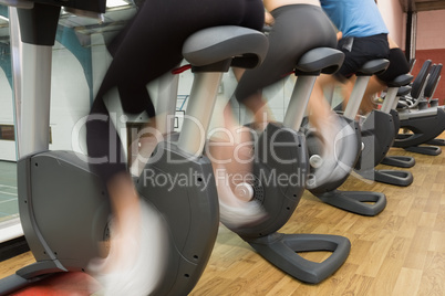 People riding on exercise bikes