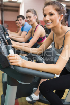 Four people enjoying time on exercise bikes