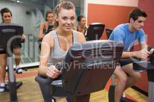 Smiling woman in spin class