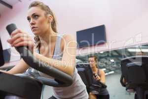 Woman training on exercise bike in a spinning class