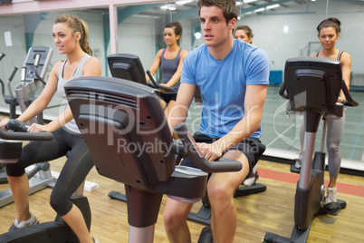 Spinning class riding on a exercise bikes