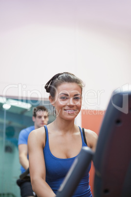 Woman on exercise bike in spinning class