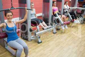 Four women training on weight machines