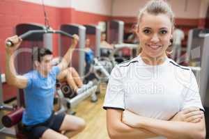 Female trainer smiling in front of class