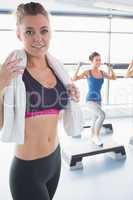 Woman with towel around her neck at aerobics class