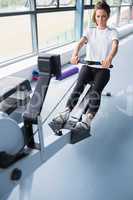 Energetic woman training on row machine