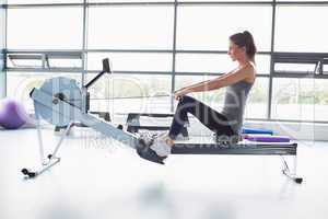Woman working out on row machine