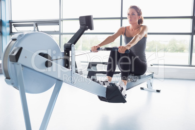 Woman training on row machine