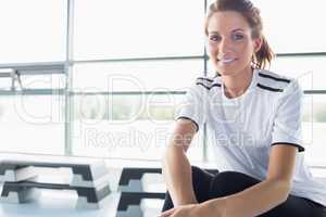 Woman sitting on row machine