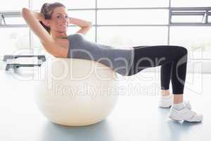 Woman doing sit-ups on exercise ball