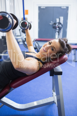 Happy woman lifting weights