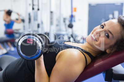 Smiling woman lifting weights