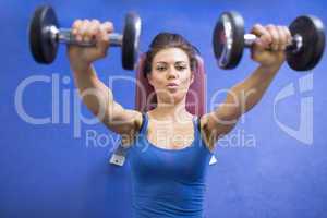 Woman energetically lifting weights