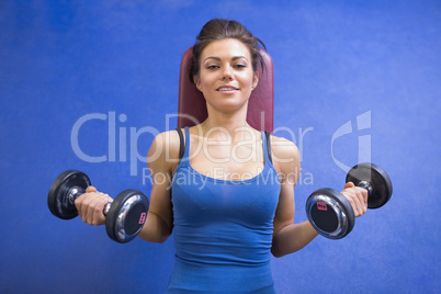 Woman lifting weights while lying