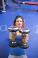 Woman straining to lift weights