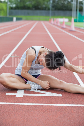 Woman stretching on a track