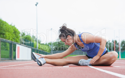 Woman stretching in a stadium