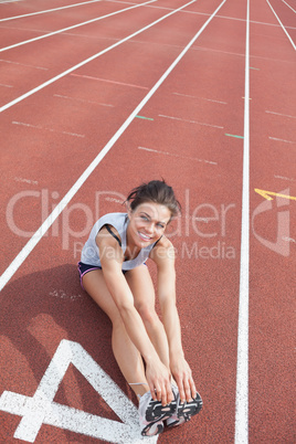Female runner stretching her legs