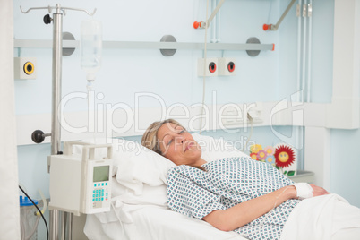 Female patient lying in hospital bed