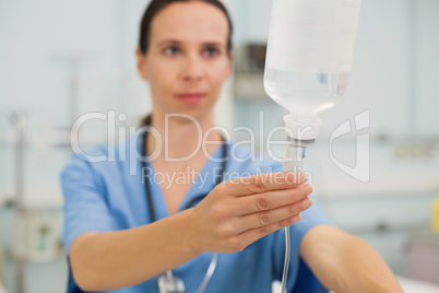 Nurse adjusting drip