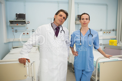 Doctor and nurse in hospital bedroom