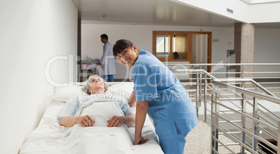Nurse smiling next to an elderly lady