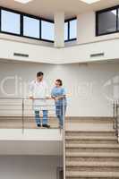 Nurse and doctor having a discussion at top of stairwell