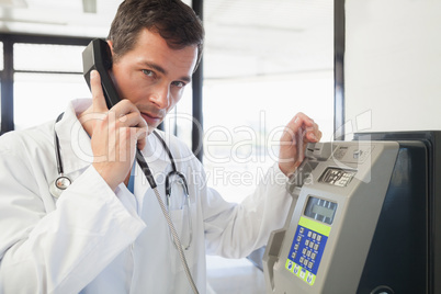 Doctor phoning in the hospital