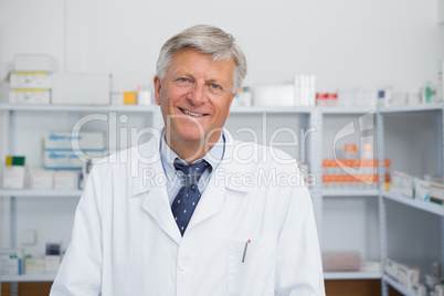 Smiling doctor in a pharmacy