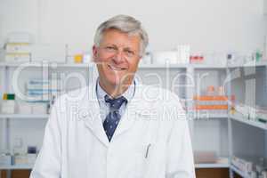 Smiling doctor in a pharmacy