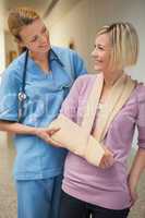 Nurse smiling with patient in arm sling
