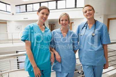 Three nurses leaning against railing