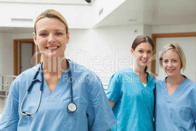 Two nurses in the background and one in the foreground