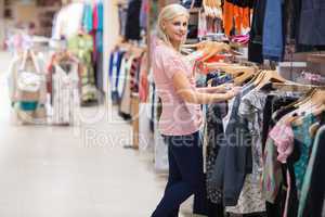 Woman is searching clothes smiling