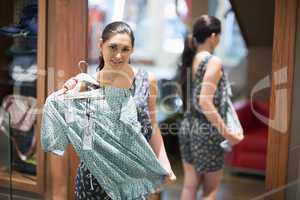 Woman holding up shirt