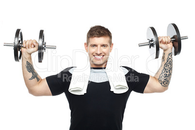 Young bodybuilder exercising, toning his biceps