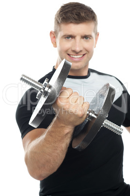 Gym instructor posing with heavy dumbbell