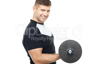 Side pose of gym instructor lifting weights