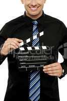 Cropped image of man with clapboard