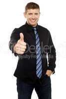 Smart young executive showing thumbs up