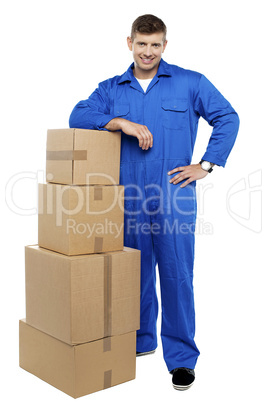 Relocation staff member resting against stack of cartons