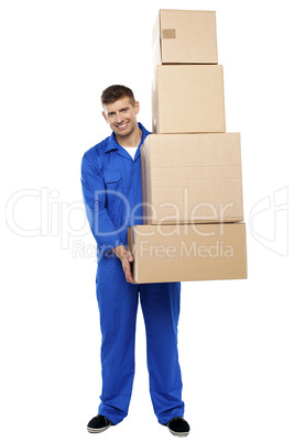 Delivery guy holding pile of cardboard boxes