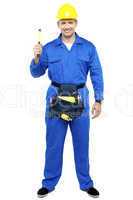 Industrial contractor holding hammer. Full length shot